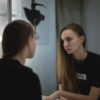 Portrait of a young woman reflecting in a mirror, creating a moody and introspective atmosphere.
