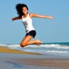 woman, beach, nature, jump, happy woman, female, happy, smiling, smile, waves, sand, sea, ocean, ocean waves, brunette, brunette woman, jumping girl, shore, seashore