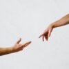 two hands reaching toward each other