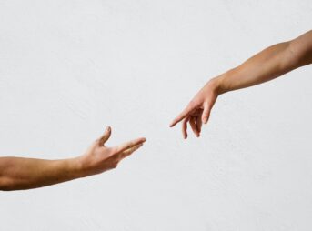 two hands reaching toward each other