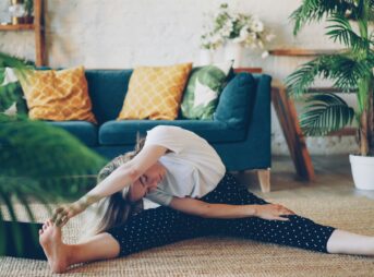 Woman stretching on floor in a living room