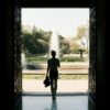 A man is walking out of a doorway