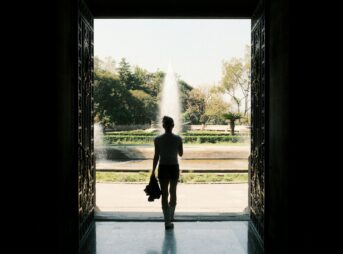 A man is walking out of a doorway