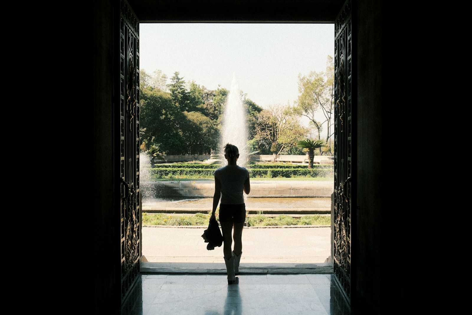 A man is walking out of a doorway