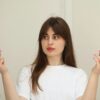 a woman holding two different types of skin care products