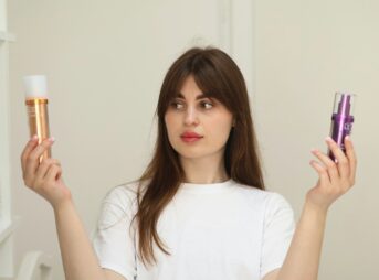 a woman holding two different types of skin care products