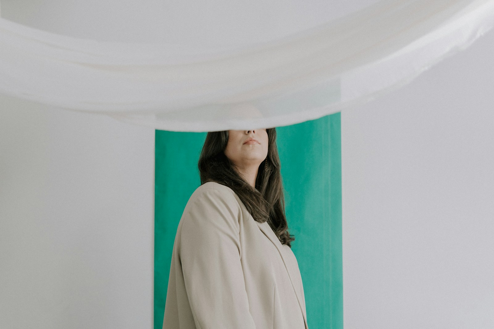 a woman standing in front of a green wall