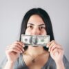 woman holding a 1 us dollar bill