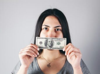 woman holding a 1 us dollar bill