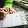 A person writing on a piece of paper