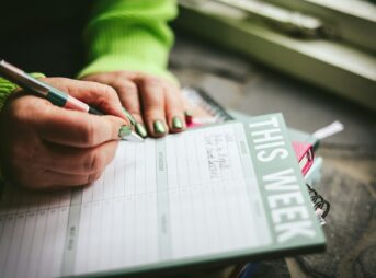 A person writing on a piece of paper