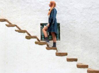 woman climbing on brown concrete stairs