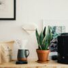 black ceramic mug beside black ceramic mug on brown wooden table