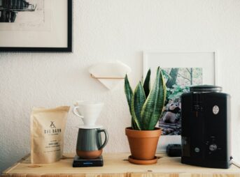 black ceramic mug beside black ceramic mug on brown wooden table